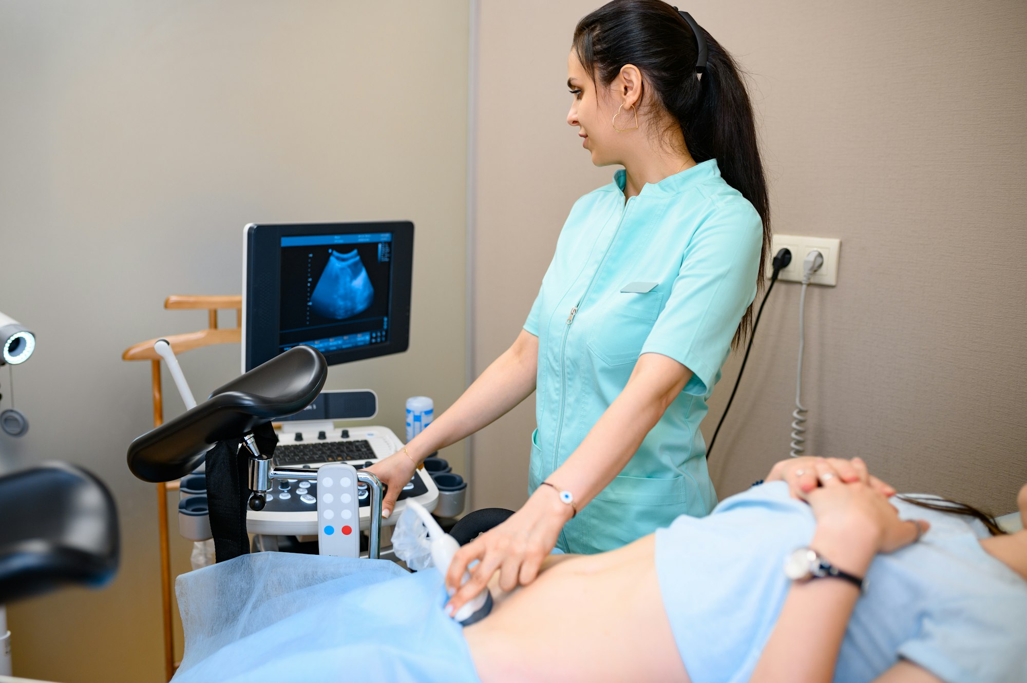 Female gynecologist makes ultrasound scan