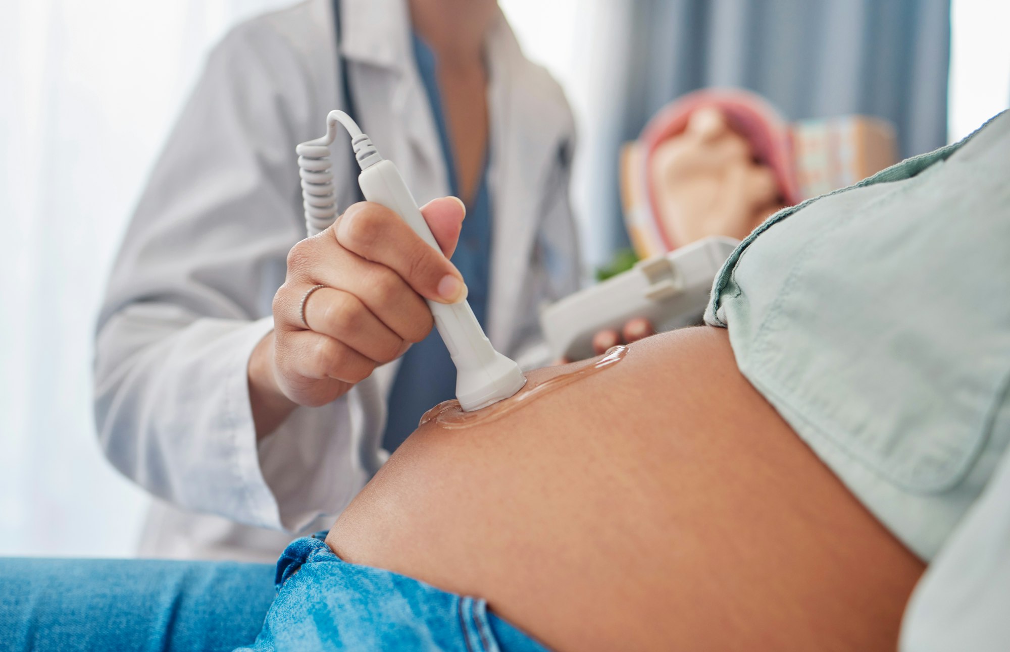 Pregnant woman, ultrasound and doctor hands with abdomen scan for baby healthcare, medical support