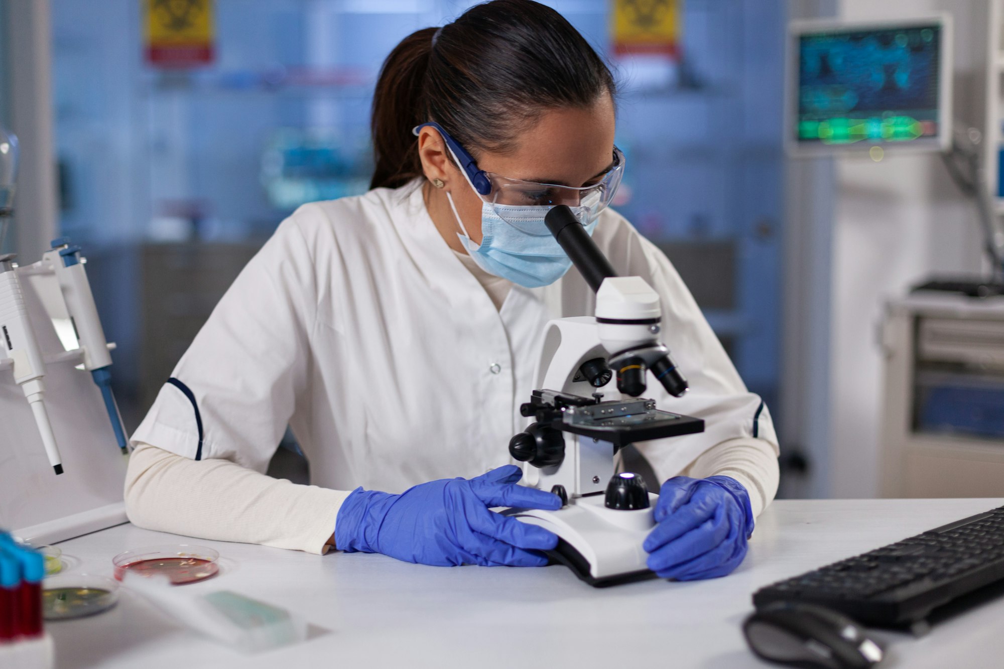 Specialist researcher analyzing genetic sample using medical microscope